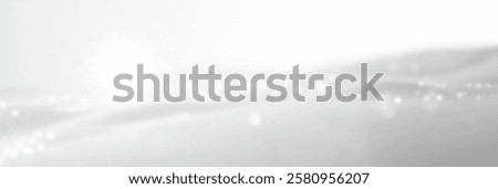 Soft white waves with sparkling light reflections creating a tranquil atmosphere.