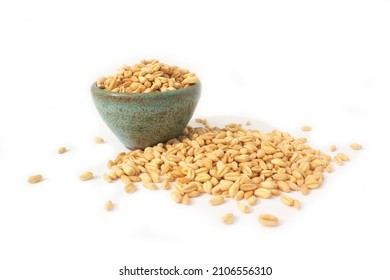 Soft White Wheat Grains Overflowing Pottery Bowl Isolated On White