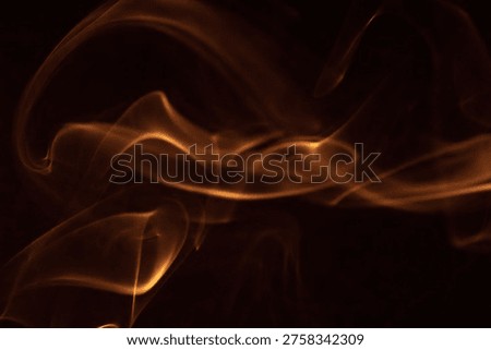 Soft wisps of smoke create an elegant flow against a dark background