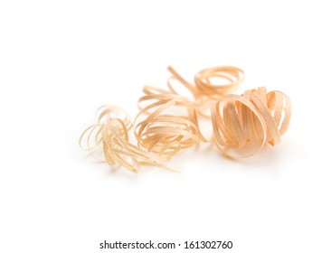 Soft wood shavings isolated on white. Shallow depth of field.