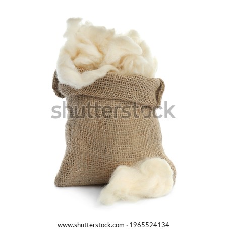 Soft wool and sack on white background