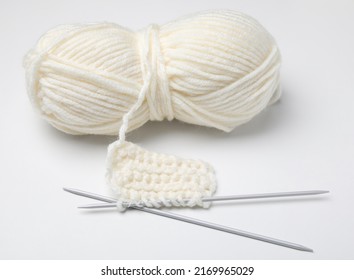 Soft Woolen Yarn, Knitting And Metal Needles On White Background