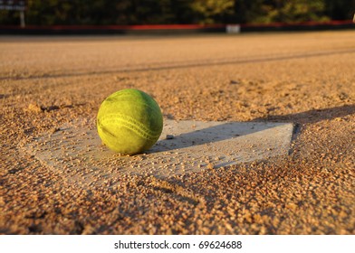 Softball On Home Plate On Ball Field