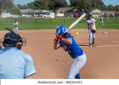 Softball Pitcher Throwing The Curve Ball To The Batter. 