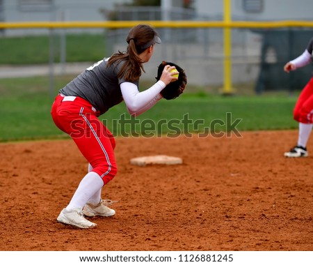 Softball Player Making a Throw for an Out
