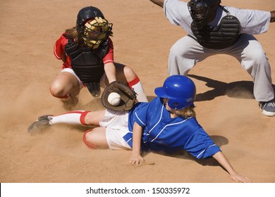 Softball Player Sliding Into Home Plate While Umpire Rules Safe