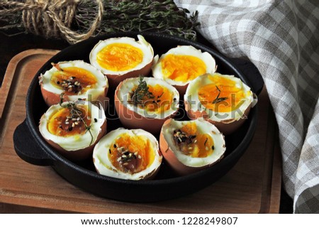 Soft-boiled eggs in the shell in a small skillet. Useful stylish breakfast. Keto breakfast.