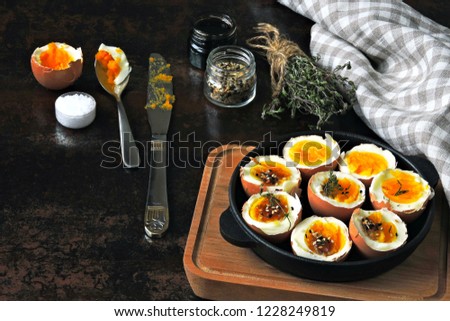 Soft-boiled eggs in the shell in a small skillet. Useful stylish breakfast. Keto breakfast.