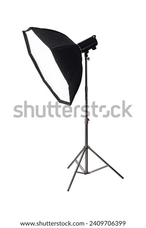 Softbox with flash on tripod stand isolated on white background.
