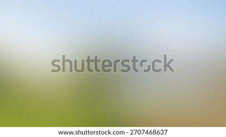 A soft-focus, impressionistic landscape featuring rolling green hills under a hazy, pale blue sky, evoking a sense of tranquility.