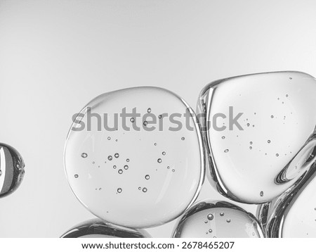 Soft-focused transparent water bubbles with small droplets on white background.