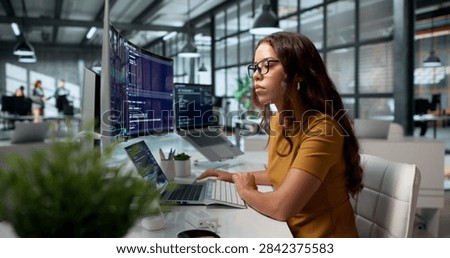 Software Developer Calmly Codes Using Cloud-based IDE On Her Desktop Workspace.