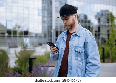 Software developer checking a smartphone during a busy workday. Mobile communication, technology, productivity and modern tech industry lifestyle concept.