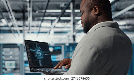 Software developer in data center uses AI technology on laptop to optimize storage volumes. IT expert in server hub facility using artificial intelligence to ensure seamless operations, camera B