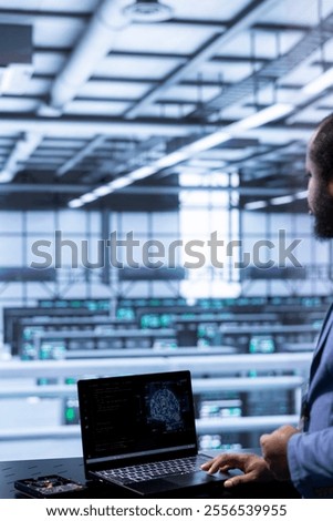 Software developer in data center using laptop to visualize artificial intelligence neural networks made up of interconnected nodes. Server room worker oversees AI systems processing information