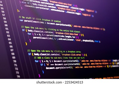 The software developer is doing javascript coding. Abstract code background. Selective focus code on computer screen