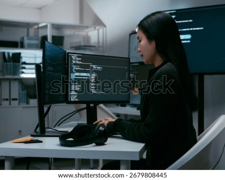 Software developer, Female Computer programmer coding on computer screen, Analysis data and Line of code, using desktop computer, writing code, developing software program sitting at desk in Office.