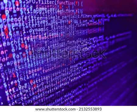 Software developer programming code on computer. Lines of code of a software with several colors. Programmer working in a software develop company office. PC software creation business