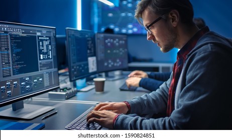 Software Developer Programming, Finding Solutions while Working on Desktop Computers in Data Center System Control Room. Team of Young Professionals Doing High Tech Coding - Powered by Shutterstock