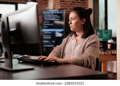 Software developer programming javascript code algorithm on computer, sitting at desk in it company office. Tech enginner working with html database script in cyber security agency.