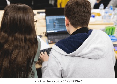 Software developer students in auditorium hall working on computer and laptop, programming contest hackathon competition, pc with coding program app, competitive programming for software engineer