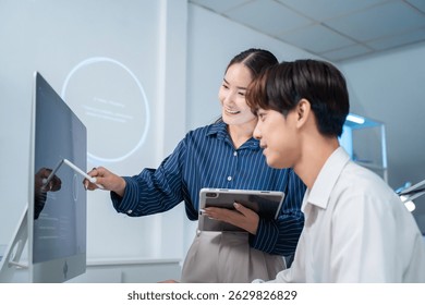 software developer talk strategy plan to executive write prompt AI bot IT app program data analytics in tech startup office.Projected visuals and glowing code on screen.AI chatbot technology concept
