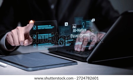 Software developer using laptop and tablet for AI-native development. Virtual interface showing coding icons, search, and artificial intelligence for modern software innovation.