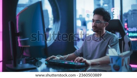 Software Developer Wearing Sci-Fi Monocle with Augmented Reality and Artificial Intelligence Functions. Young Handsome Man Working on a Computer in a Futuristic Cyber Reality Agency Room