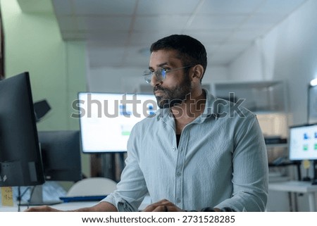Software developer working on data analytics,AI programming.Confident professional business man use desktop computer working in modern office environment.Image People idea for Ai technology,Cybersecurity,Coding,IT industry,Data Science concept