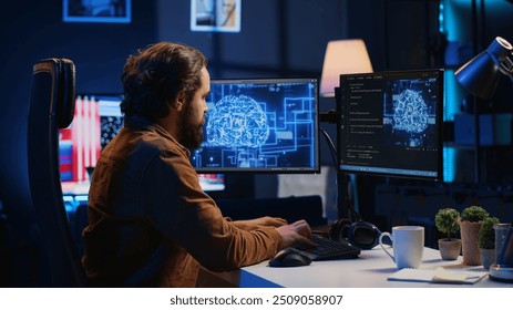Software developer writes code on multimonitor setup PC to visualize artificial intelligence neural networks. Teleworking IT employee runs AI script on computer from home office, camera A