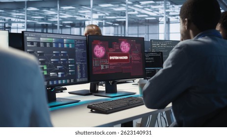 Software developers in server hub trying to protect gear from hacker stealing data. Data center colleagues struggling to erase virus after seeing system hacked notification, camera A
