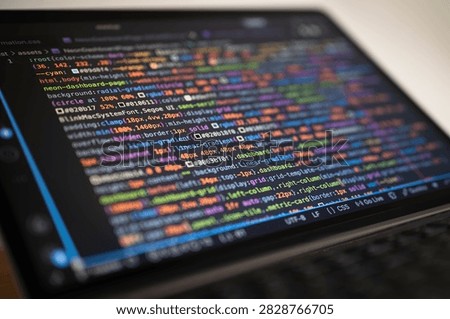 Software development code displayed on laptop screen with colorful syntax, representing web programming, frontend development, coding, debugging, digital technology and modern developer workflow.