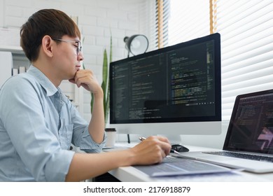 Software development concept, Male programmer read data code to thinking about developing website. 