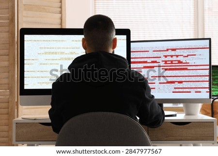 Software development and debugging, programmer working on computer code with error logs and syntax issues on dual monitors in a home office workspace