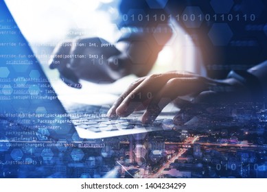 Software Development, Internet Technology, IoT Concept. Double Exposure, Man Coding Software Developer Working On Laptop Computer And City With Binary, Computer Code, Big Data On Virtual Screen