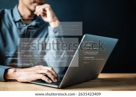 Software development. Programming engineer. Coding application. A man is typing on a laptop with a screen displaying a bunch of code. The man is deep in thought. Concept of concentration and focus.