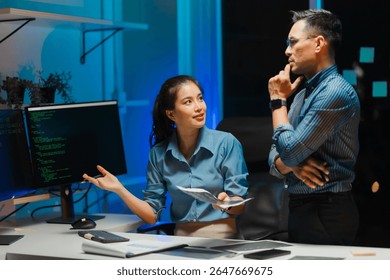 Software Development Team Discussing Code at Night