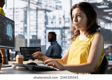 Software engineer doing job, creating machine learning models that can process and analyze data to automate decision making processes. Focused IT specialist programming in workspace using PC - Powered by Shutterstock