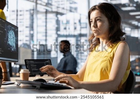 Software engineer doing job, creating machine learning models that can process and analyze data to automate decision making processes. Focused IT specialist programming in workspace using PC