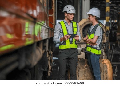 Software engineers collaborate, discuss ways to enhance a smart energy analytics app for locomotive operation. Real-time monitoring optimizes data usage and analyzes efficient consumption insights.