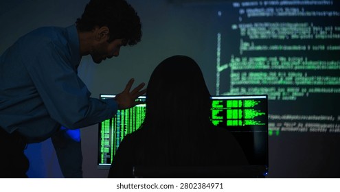 Software engineers collaborating on cybersecurity monitoring and AI powered code analysis in a modern technology workspace with multiple digital displays