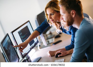 Software engineers working on project and programming in company - Shutterstock ID 1036178032