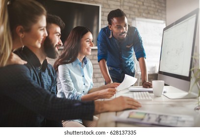 Software engineers working on project and programming in company - Shutterstock ID 628137335