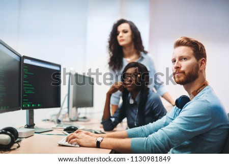 Software engineers working on project and programming in company