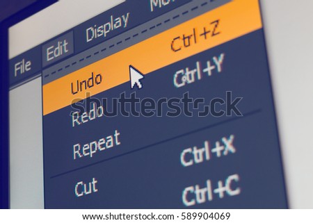 Software menu item with undo command highlighted and mouse cursor selected it, macro shot