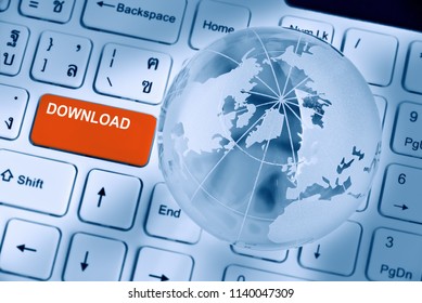 Software or program realtime online download concept : Word DOWNLOAD on red enter key button, white desktop computer keyboard with world globe and map, depicts downloading data from remote ftp server