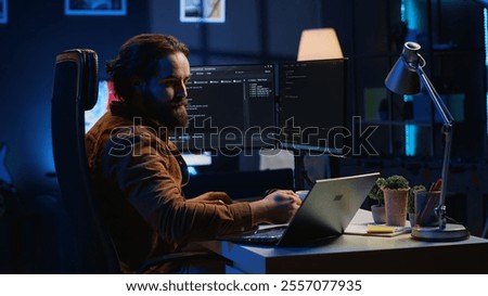 Software programmer putting headphones on while developing code, making time pass faster during remote job shift. IT professional doing multitasking in apartment office while listening music, camera A