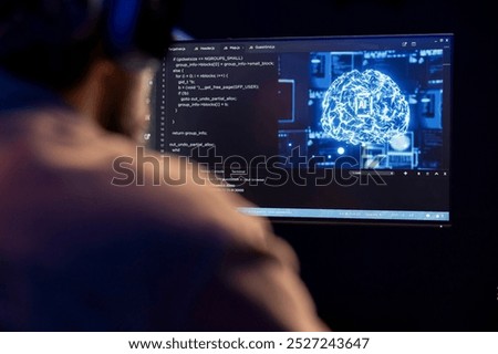 Software technician uses computer for artificial intelligence computing simulating human brain through machine learning. Freelancing IT professional working with AI deep neural networks