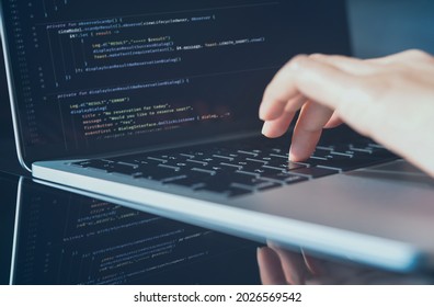 Software technology development concept. Closeup coding on screen, Woman programmer, software engineer hands coding html and programming computer script on laptop, web or app development