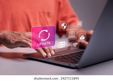 Software update or operating system upgrade. Improved functionality in the new version and improved security. Person use laptop with update icons on virtual screen. 